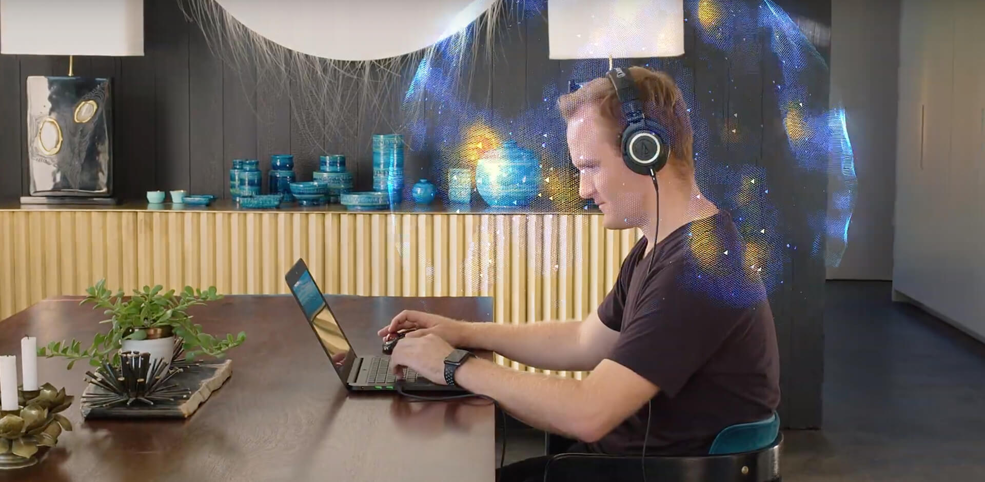 THX Spatial Audio Guy wearing headphones on his laptop